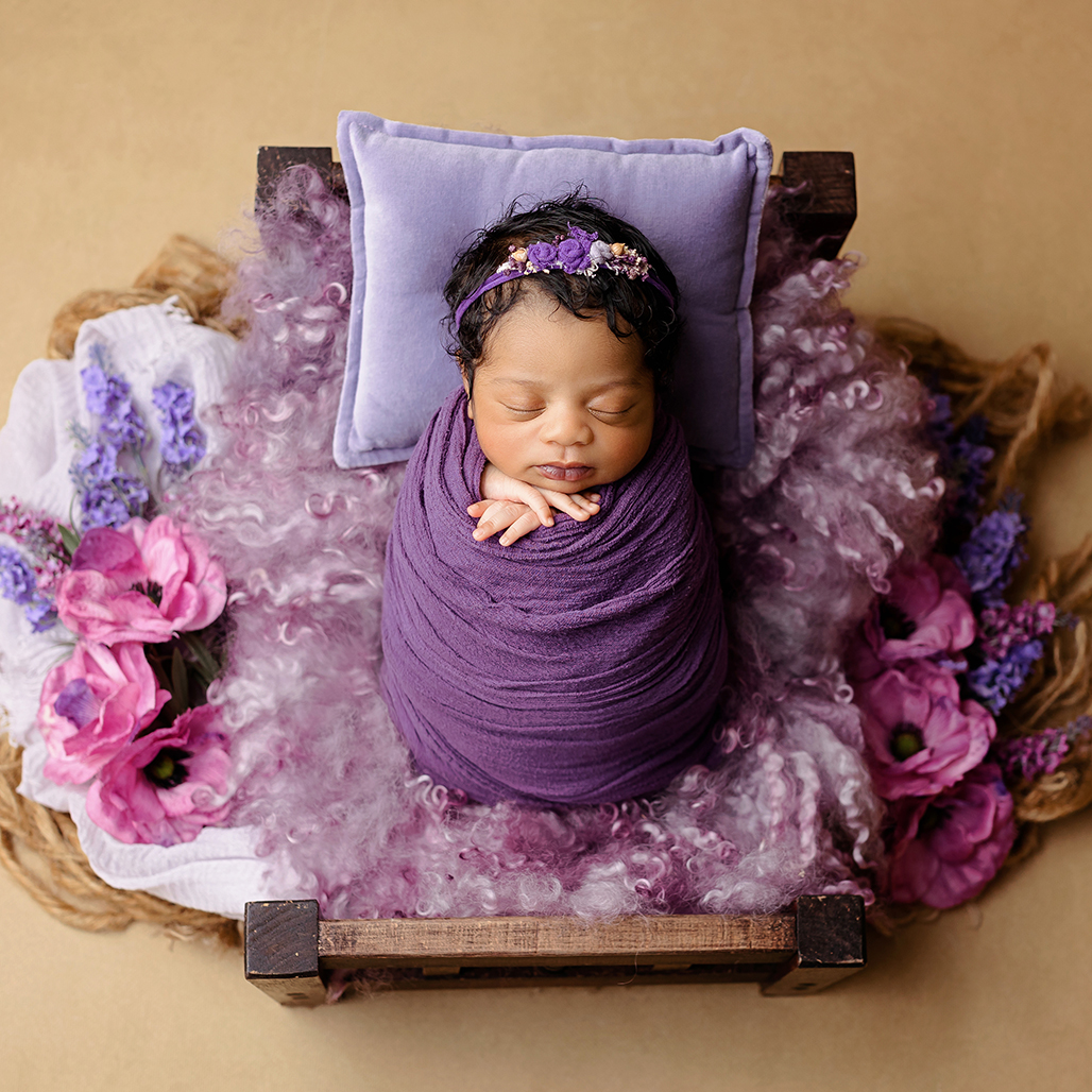 girl sleeping in bed purple flowers newborn baby photographer Hertfordshire Watford