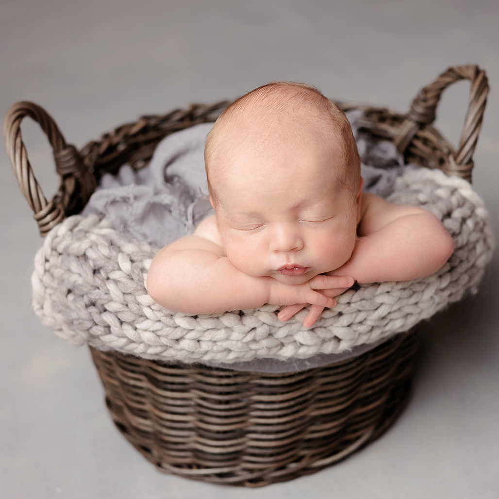 baby photoshoot boy sleeping in basket sleeping in studio newborn photography Harpenden, Hertfordshire